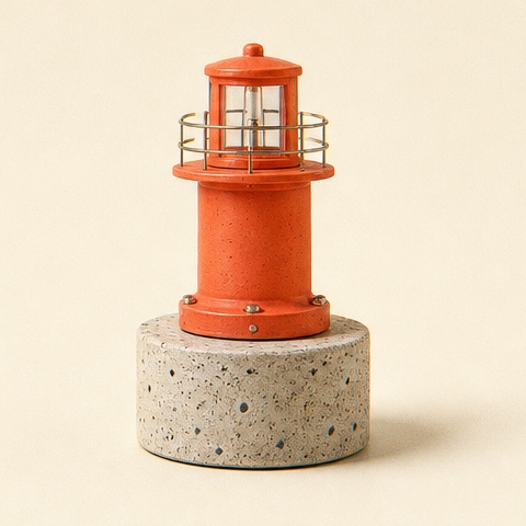 A vermilion harbor beacon waiting on speckled concrete.