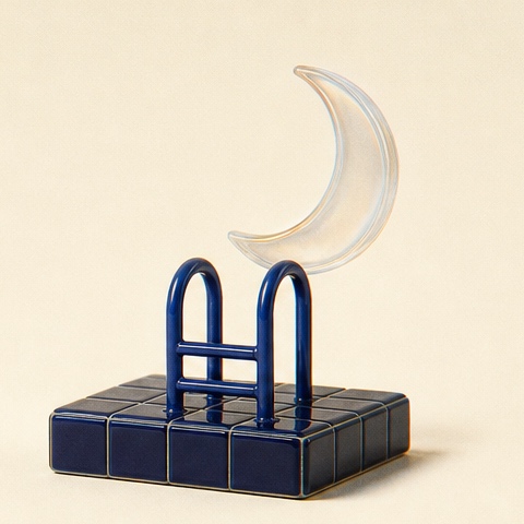 A cobalt pool ladder holding a translucent moon after closing.